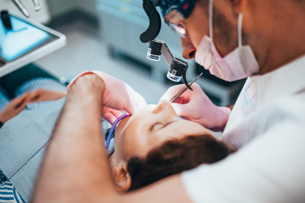 Stages of depulpation - dentist cleans dental canal and cauterizes nerve